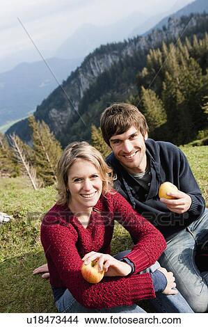 Picture - Couple eating apples while resting. Fotosearch