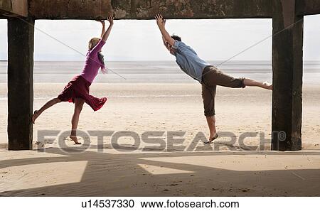 Couple exercising on beach View Large Photo Image Stock Image - Couple exercising on beach. Fotosearch