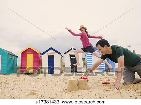 Stock Image - Couple have fun on beach. Fotosearch