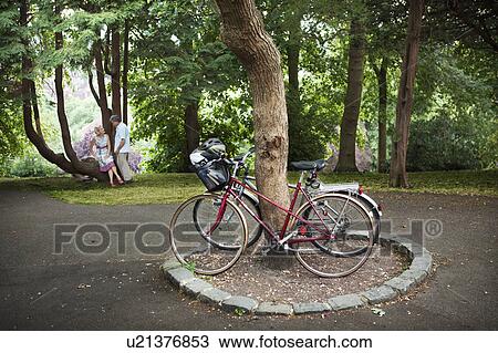 Stock Image - Couple having break from cycling. Fotosearch