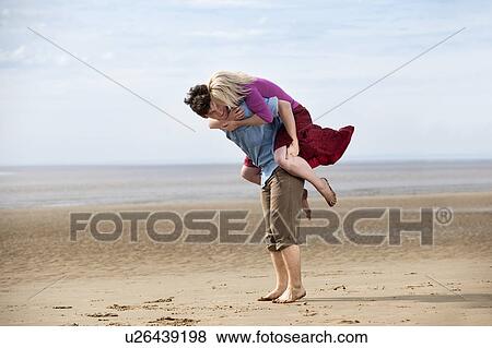 Couple having fun on beach View Large Photo Image Stock Photo - Couple having fun on beach. Fotosearch