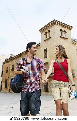 Stock Photograph - Couple holding hands in old city square. Fotosearch