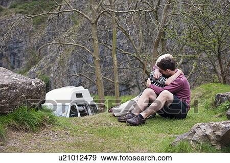 Stock Photo - Couple hugging in front of mobile home. Fotosearch