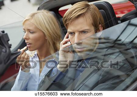 Stock Image - Couple in an electric sports car. Fotosearch