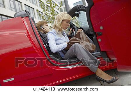 Couple in an electric sports car View Large Photo Image Stock Image - Couple in an electric sports car. Fotosearch