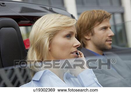 Couple in an electric sports car View Large Photo Image Stock Photo - Couple in an electric sports car. Fotosearch