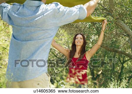 Couple laying out picnic blanket View Large Photo Image Stock Photography - Couple laying out picnic blanket. Fotosearch