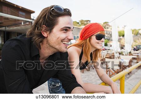 Couple leaning on rail View Large Photo Image Stock Image - Couple leaning on rail. Fotosearch