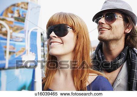 Couple looking at postcards View Large Photo Image Stock Photography - Couple looking at postcards. Fotosearch