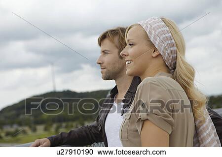 Stock Image - Couple looking into the distance. Fotosearch