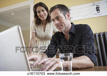 Stock Image - Couple looking to computer. Fotosearch