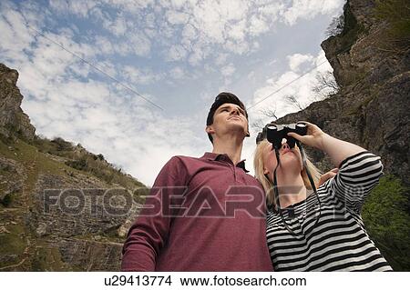 Couple looking with binoculars in valley View Large Photo Image Picture - Couple looking with binoculars in valley. Fotosearch