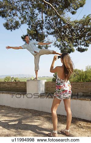 Couple on holiday fooling about View Large Photo Image Stock Photo - Couple on holiday fooling about. Fotosearch