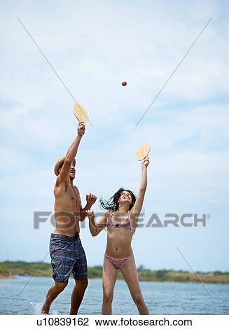 Couple playing beach ball at the beach View Large Photo Image Stock Image - Couple playing beach ball at the beach. Fotosearch