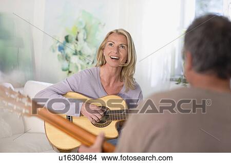 Couple playing guitars View Large Photo Image Picture - Couple playing guitars. Fotosearch