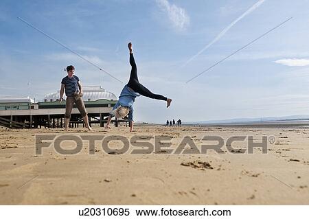 Stock Photography - Couple playing on beach. Fotosearch