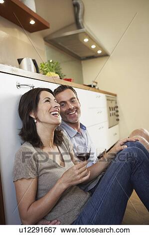 Couple relaxing in kitchen View Large Photo Image Stock Photo - Couple relaxing in kitchen. Fotosearch