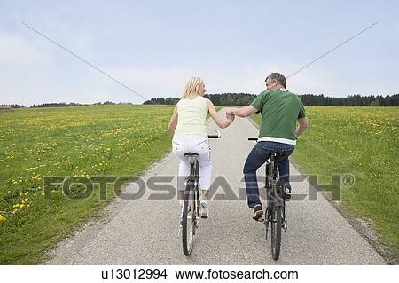 Picture - Couple riding bikes. Fotosearch
