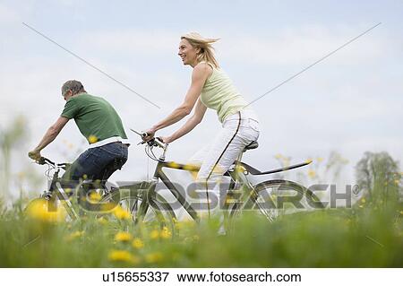 Couple riding bikes View Large Photo Image Stock Photo - Couple riding bikes. Fotosearch