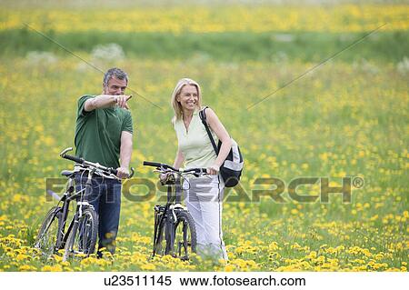 Couple riding bikes View Large Photo Image Stock Photography - Couple riding bikes. Fotosearch