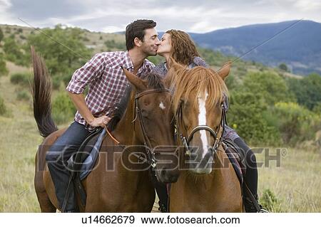 Stock Photo - Couple riding horses. Fotosearch