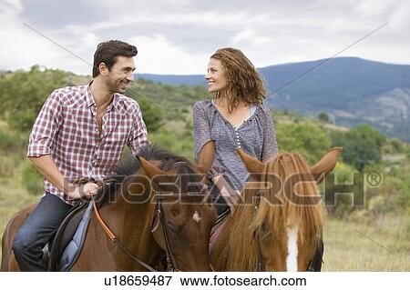 Couple riding horses View Large Photo Image Stock Photo - Couple riding horses. Fotosearch
