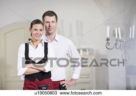 Stock Image - Couple running a restaurant. Fotosearch