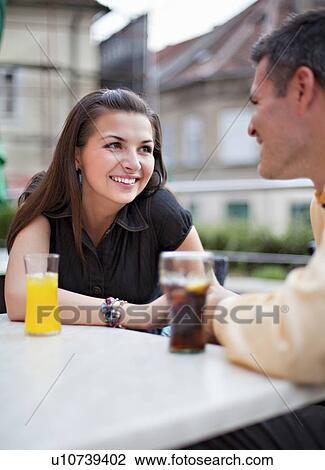 Couple sitting in cafÈ View Large Photo Image Stock Image - Couple sitting in cafÈ. Fotosearch