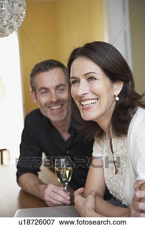 Stock Photo - Couple sitting on table. Fotosearch