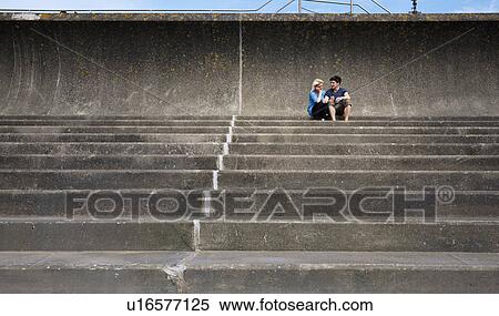 Couple sitting together on steps View Large Photo Image Stock Photography - Couple sitting together on steps. Fotosearch
