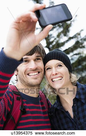 Stock Photography - Couple taking photo. Fotosearch