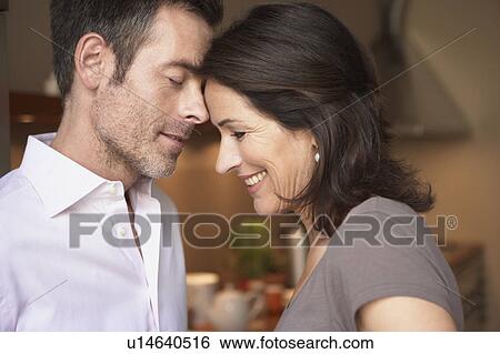 Couple touching heads View Large Photo Image Stock Photograph - Couple touching heads. Fotosearch