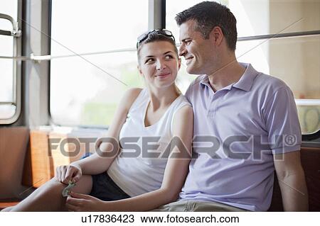 Stock Image - Couple travelling in funicular train. Fotosearch