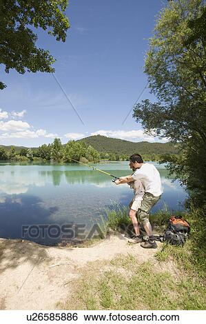 Stock Photograph - Couple trying to catch a fish. Fotosearch