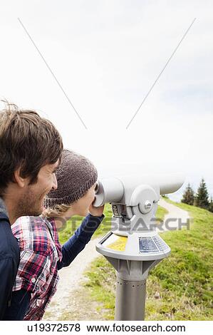 Stock Photo - Couple using telescope. Fotosearch