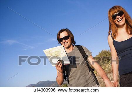 Couple walking hand in hand View Large Photo Image Stock Photograph - Couple walking hand in hand. Fotosearch