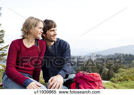 Stock Photography - Couple watching landscape on mountain. Fotosearch