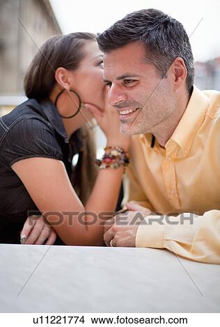 Picture - Couple whispering. Fotosearch