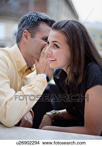 Couple whispering View Large Photo Image Picture - Couple whispering. Fotosearch