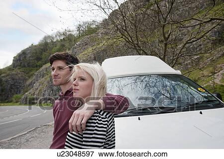 Couple with motor home by road View Large Photo Image Stock Photo - Couple with motor home by road. Fotosearch