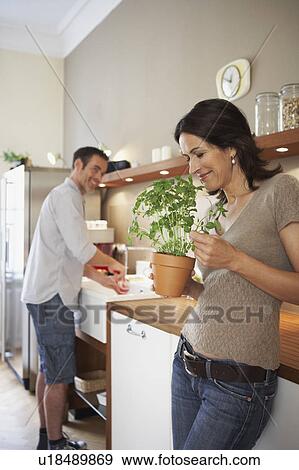 Couple working in kitchen View Large Photo Image Stock Photo - Couple working in kitchen. Fotosearch