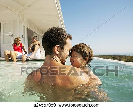 Stock Photo - Dad with child in pool. Fotosearch