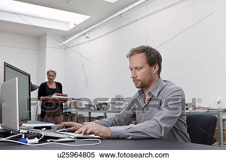Designer working at his desk View Large Photo Image Stock Photography - Designer working at his desk. Fotosearch