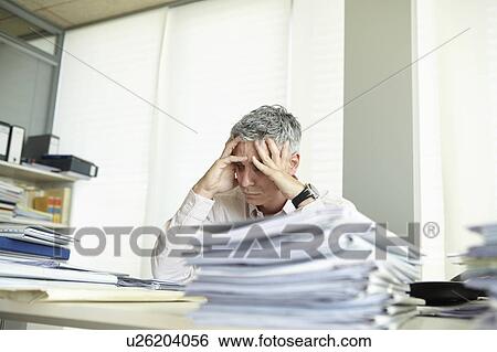 Despondent man behind desk View Large Photo Image Stock Photograph - Despondent man behind desk. Fotosearch