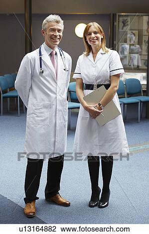 Doctor and nurse in waiting area View Large Photo Image Stock Image - Doctor and nurse in waiting area. Fotosearch