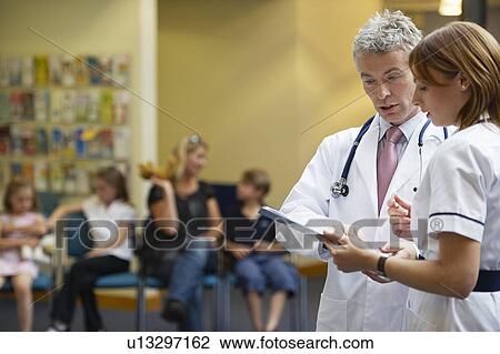 Doctor and nurse in waiting area View Large Photo Image Stock Image - Doctor and nurse in waiting area. Fotosearch