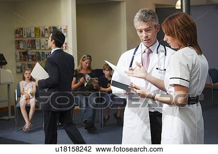 Doctor and nurse in waiting area View Large Photo Image Stock Image - Doctor and nurse in waiting area. Fotosearch