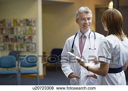 Doctor and nurse in waiting area View Large Photo Image Stock Photo - Doctor and nurse in waiting area. Fotosearch