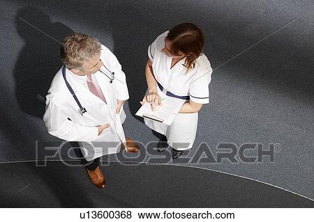 Doctor and nurse talking View Large Photo Image Stock Photo - Doctor and nurse talking. Fotosearch