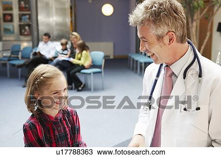Stock Image - Doctor and patients in waiting area. Fotosearch
